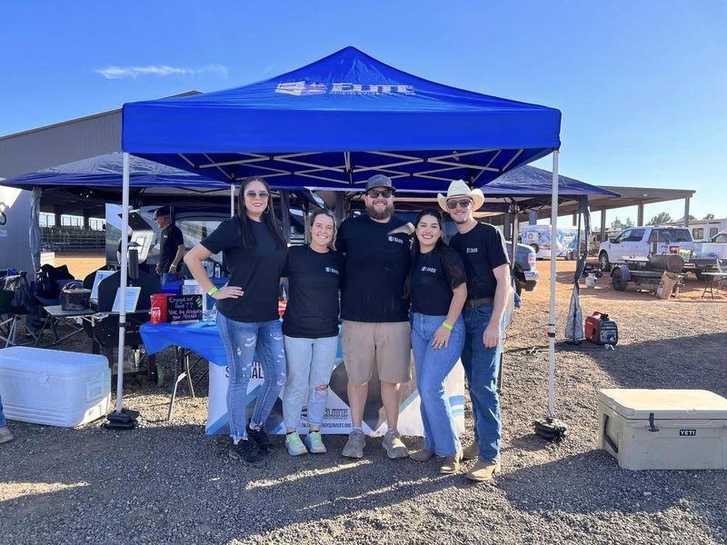 The Elite team under the company tent at an industry event