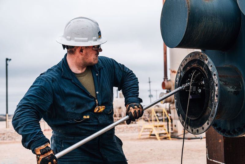 Field technician running the scanner pole into a fire tube