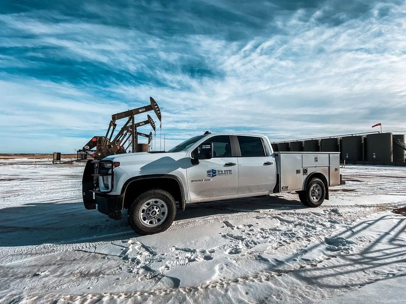Elite service truck at a pumpjack on a snowy location